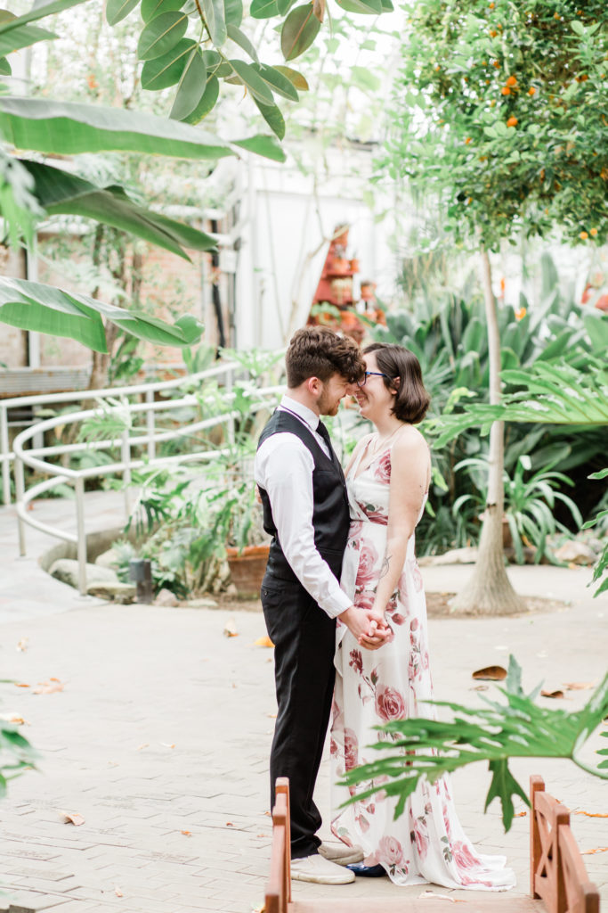 A couple shares a kiss at their Potawatomi Conservatory engagement session.